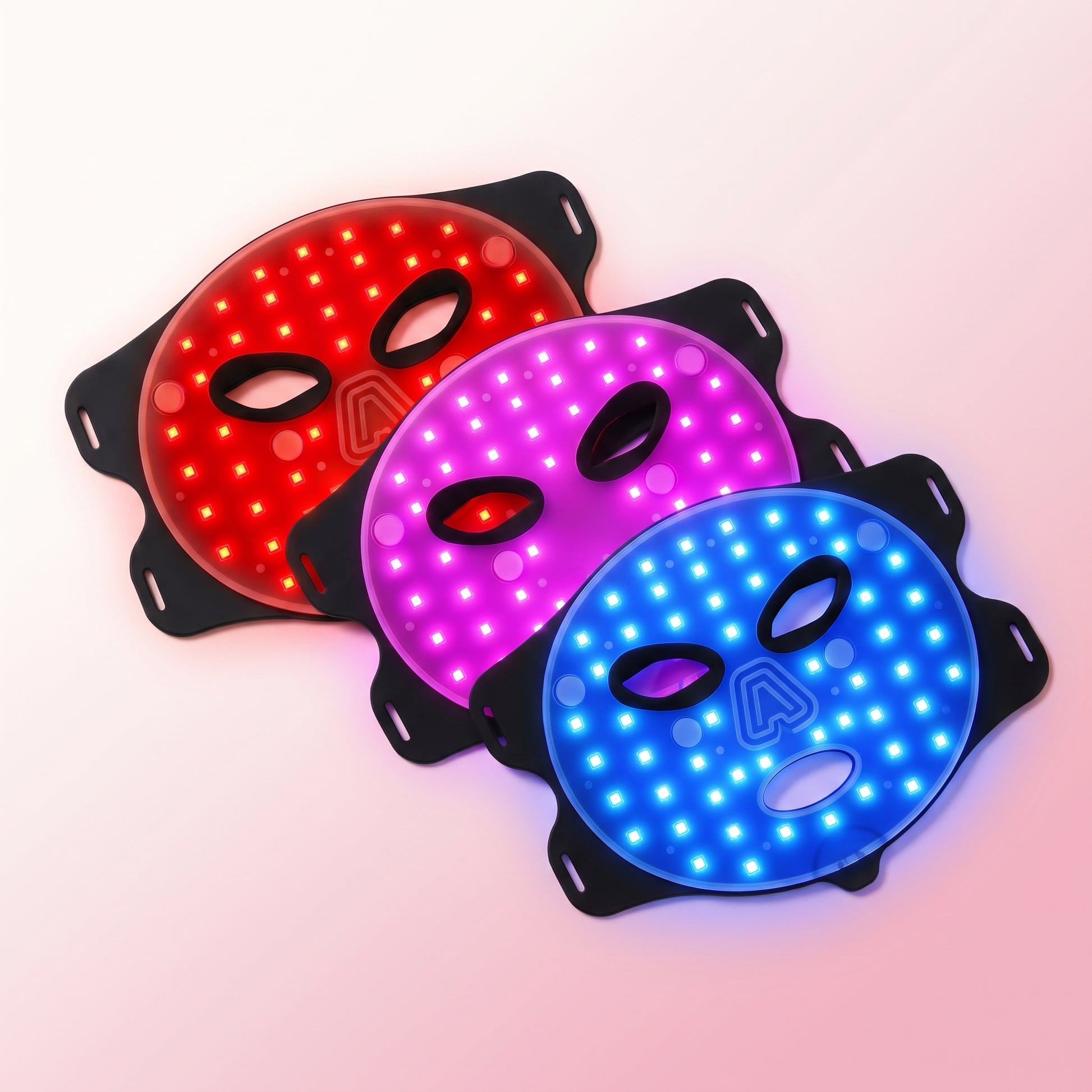 Modes | Lumina Pro LED light therapy mask showing its red, purple and blue light modes, flat lay