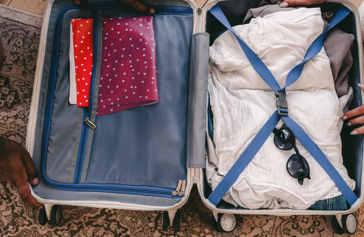 Open suitcase neatly packed with clothes and travel essentials