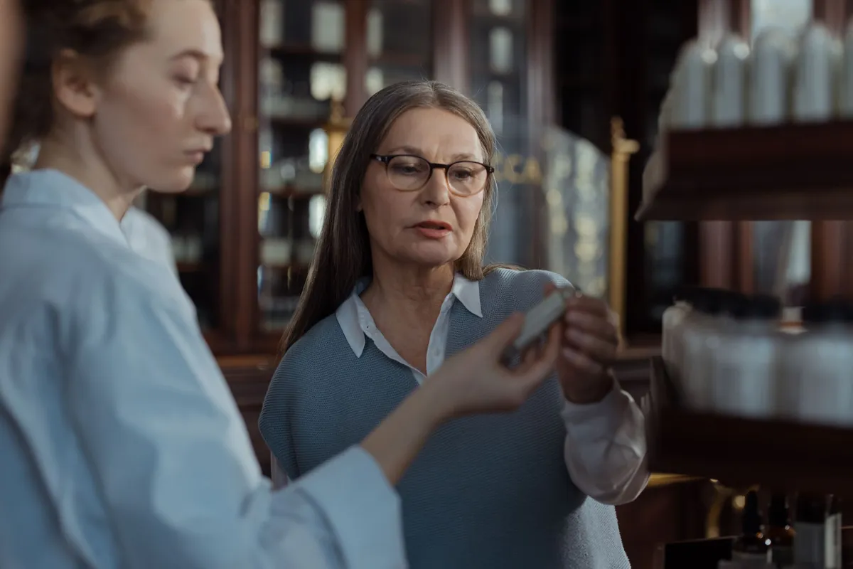 Woman discussing medication with a pharmacist