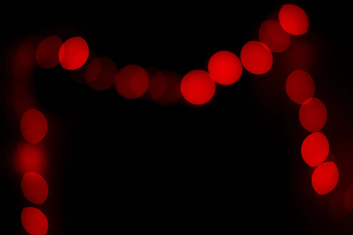 Soft red lights glowing against a dark background